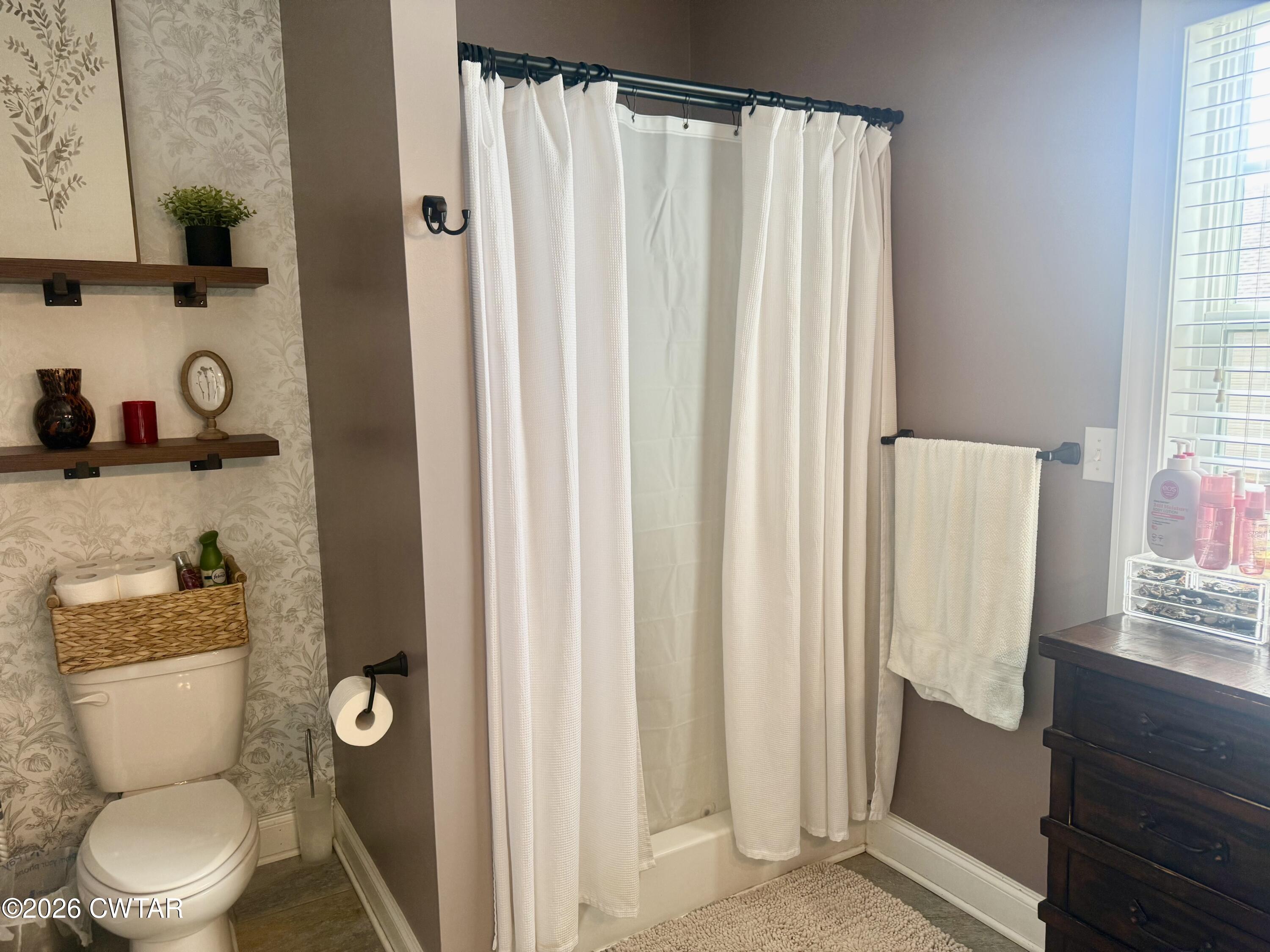 601 Locust Street Troy, TN 38260 - Photo 16 of 22 a white toilet sitting next to a bathroom sink