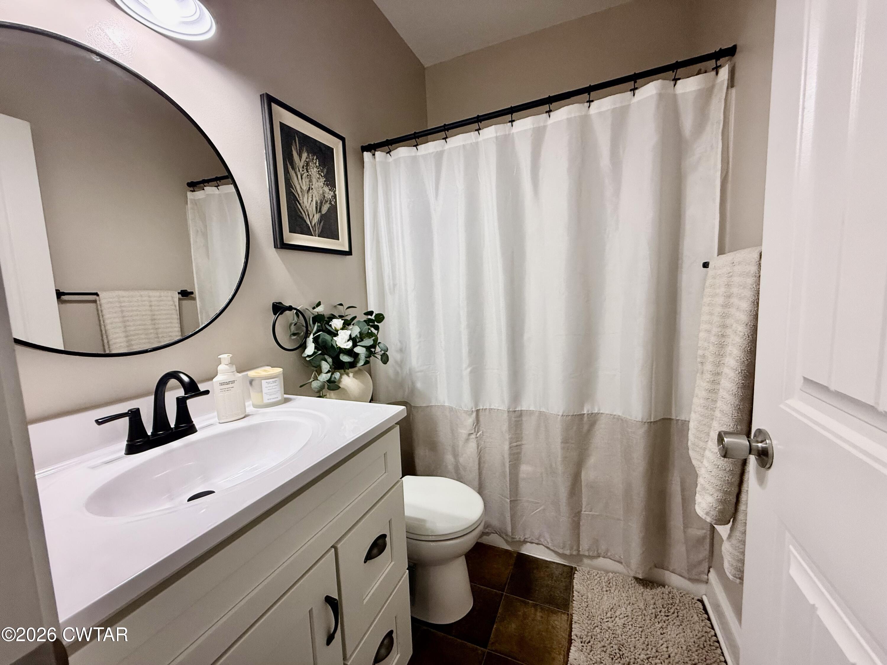 601 Locust Street Troy, TN 38260 - Photo 17 of 22 a bathroom with a sink a toilet and a mirror