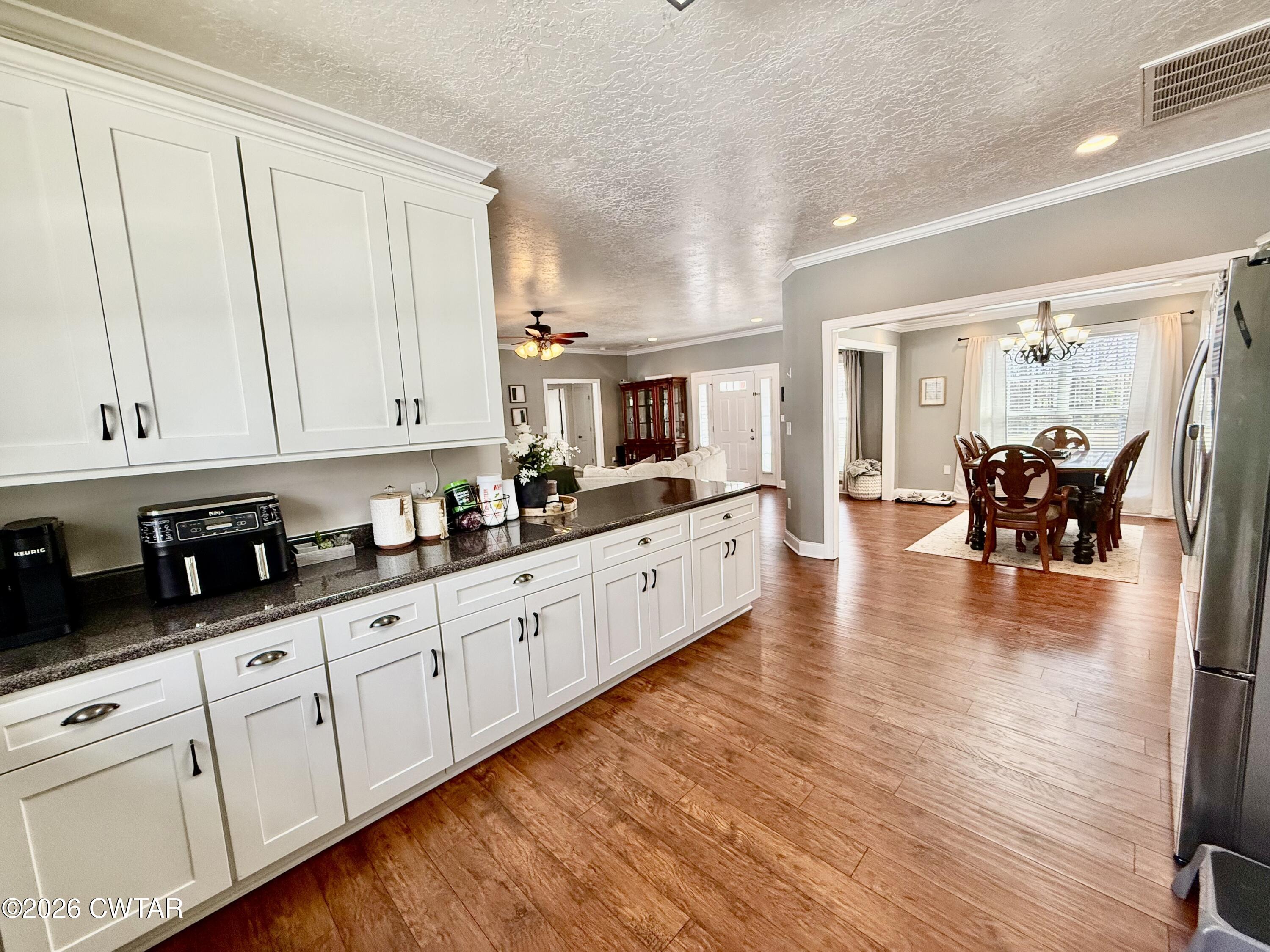 601 Locust Street Troy, TN 38260 - Photo 10 of 22 a large white kitchen with cabinets