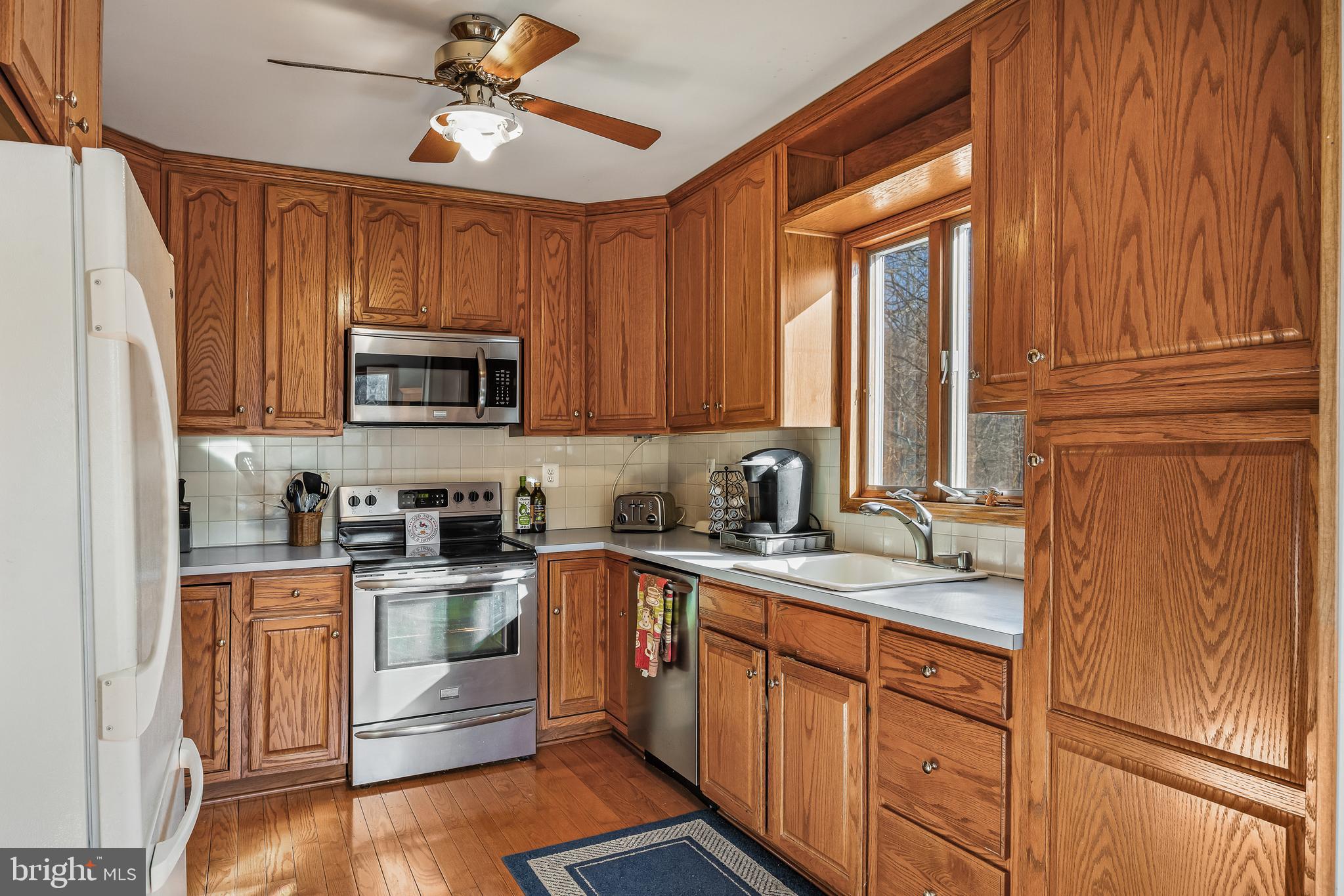 170 Birmingham Road Mount Holly, NJ 08060 - Photo 38 of 55 a kitchen with granite countertop wooden cabinets stainless steel appliances a sink and a window