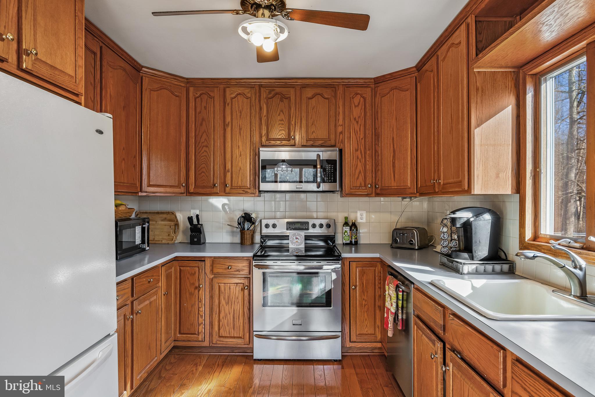 170 Birmingham Road Mount Holly, NJ 08060 - Photo 39 of 55 a kitchen with stainless steel appliances granite countertop a stove a sink dishwasher and a microwave oven with cabinets
