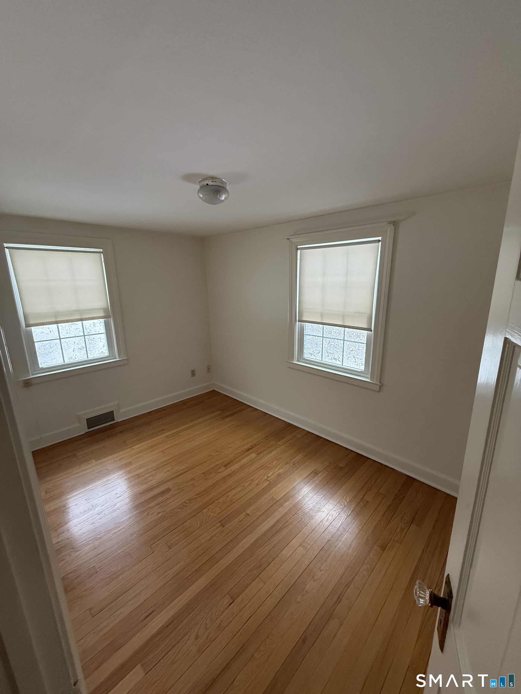 336 Ridgewood Road West Hartford, CT 06107 - Photo 11 of 21 an empty room with wooden floor and windows