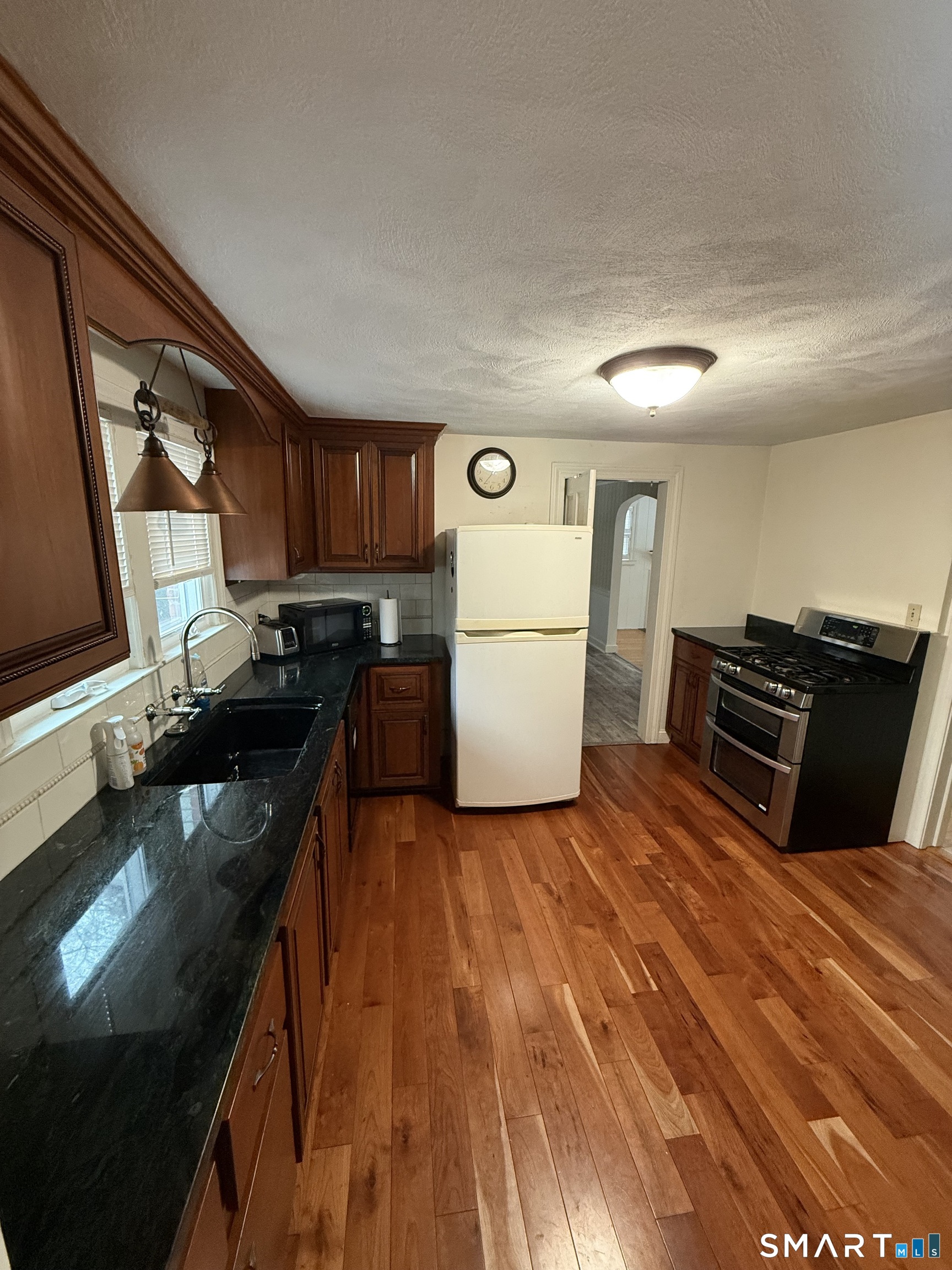 336 Ridgewood Road West Hartford, CT 06107 - Photo 6 of 21 a kitchen with a refrigerator and a stove top oven