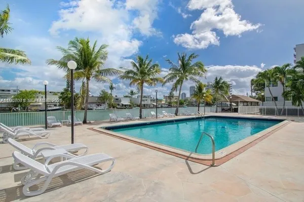 a view of a swimming pool with a lounge chairs