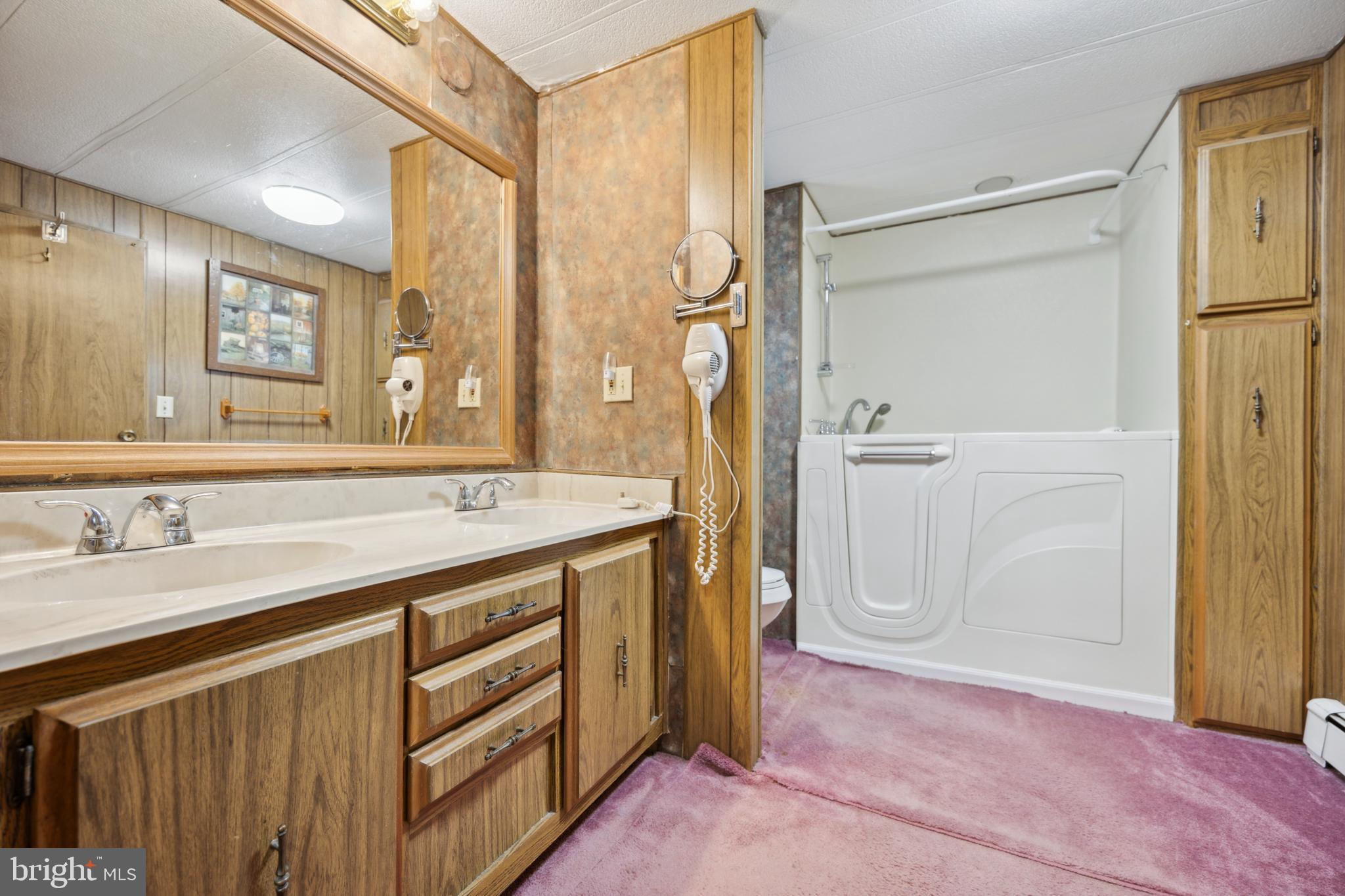 4140 Davis Drive Morrisville, PA 19067 - Photo 11 of 14 a spacious bathroom with a granite countertop sink mirror and a shower