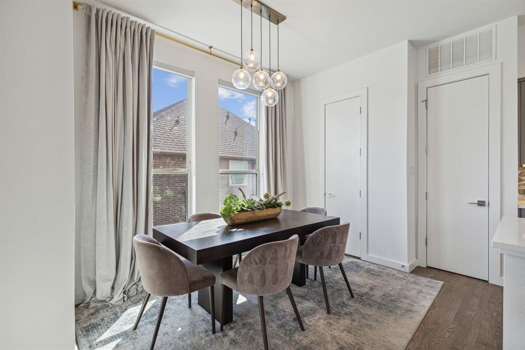 5015 Manett Street, Unit 101 Dallas, TX 75206 - Photo 12 of 25 a view of a dining room with furniture and chandelier