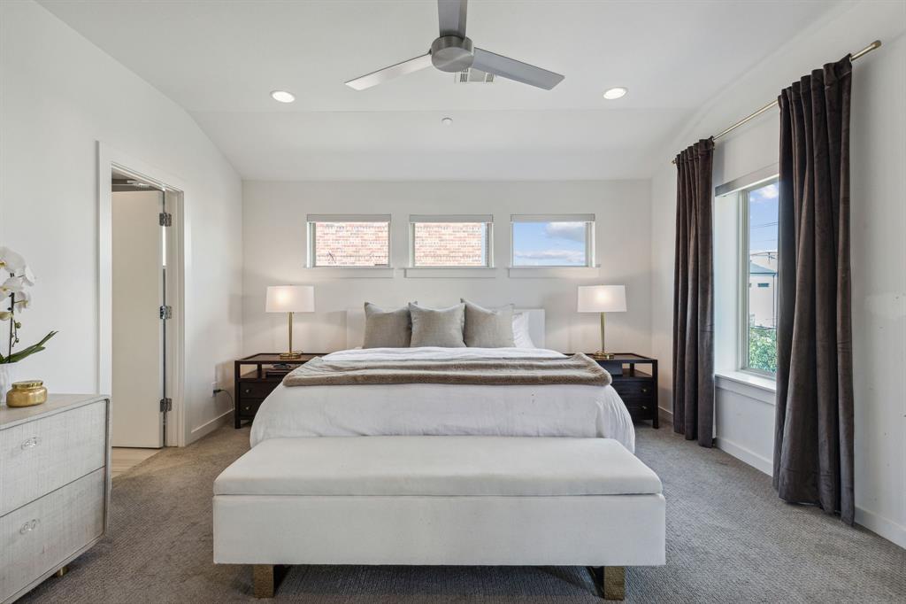 5015 Manett Street, Unit 101 Dallas, TX 75206 - Photo 17 of 25 a spacious bedroom with a bed and large window