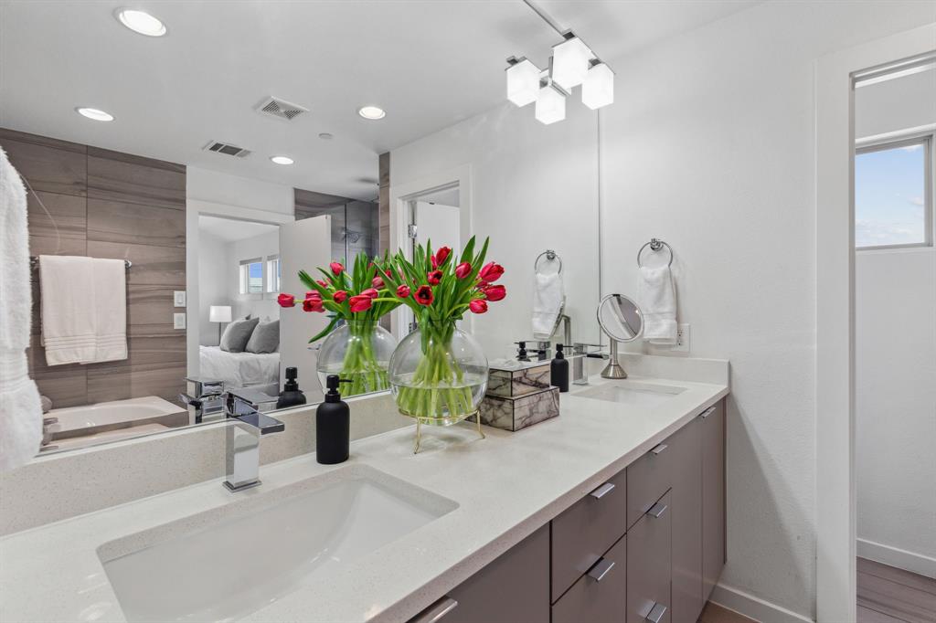 5015 Manett Street, Unit 101 Dallas, TX 75206 - Photo 19 of 25 a bathroom with a sink a faucet a potted plant and a mirror