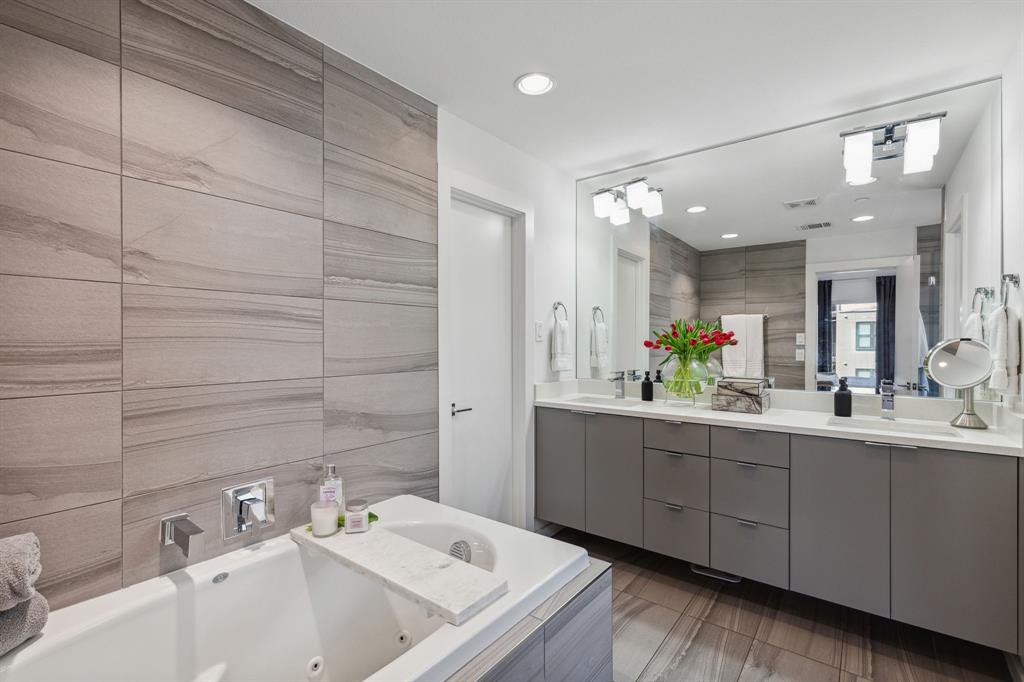 5015 Manett Street, Unit 101 Dallas, TX 75206 - Photo 20 of 25 a bathroom with a tub sink and mirror