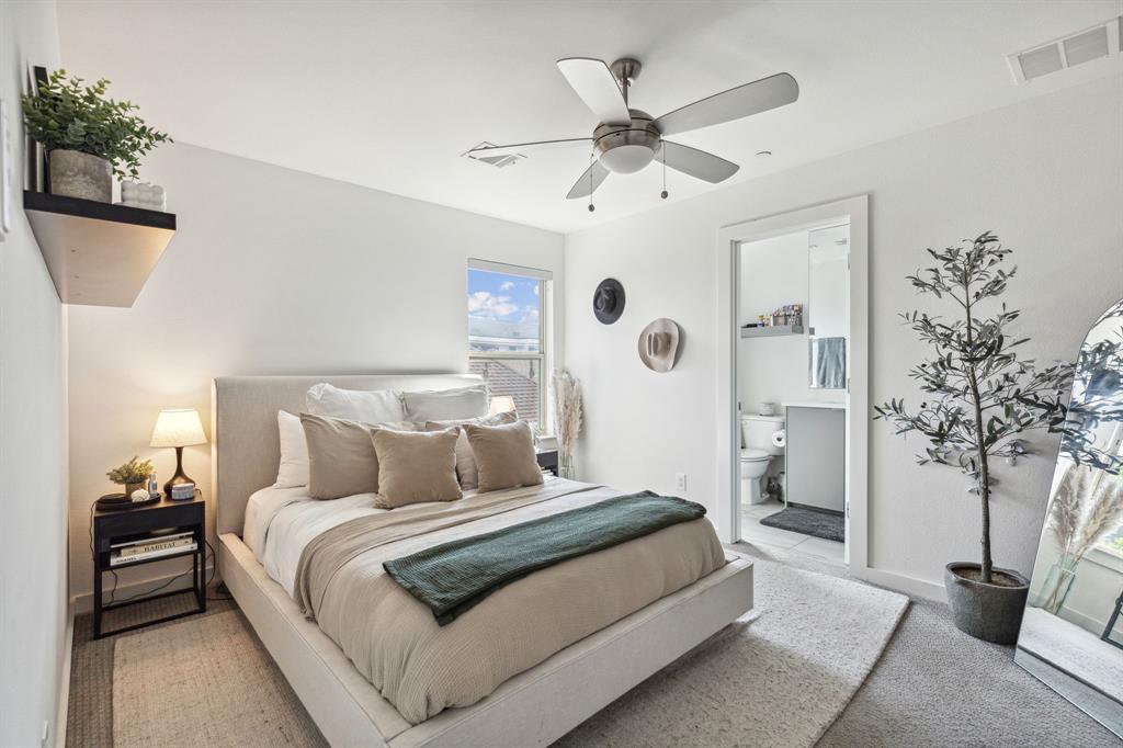 5015 Manett Street, Unit 101 Dallas, TX 75206 - Photo 23 of 25 a bedroom with a large bed and a chandelier