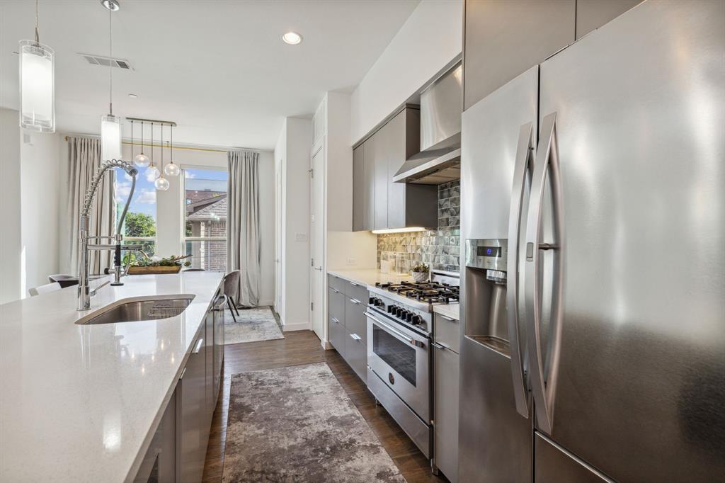 5015 Manett Street, Unit 101 Dallas, TX 75206 - Photo 8 of 25 a kitchen with stainless steel appliances granite countertop a refrigerator a stove and a sink