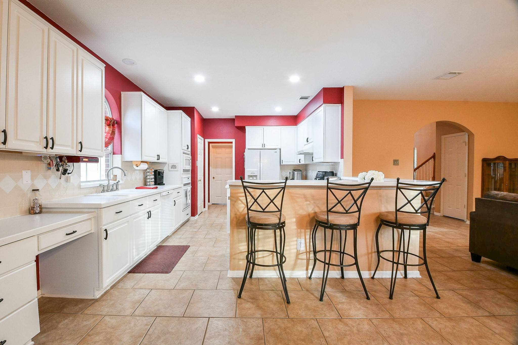 20423 Forest Drive Spring, TX 77388 - Photo 16 of 49 The kitchen features plentiful cabinets, an island and neutral tile flooring. The open layout provides a seamless flow into the adjacent living area, perfect for entertaining.