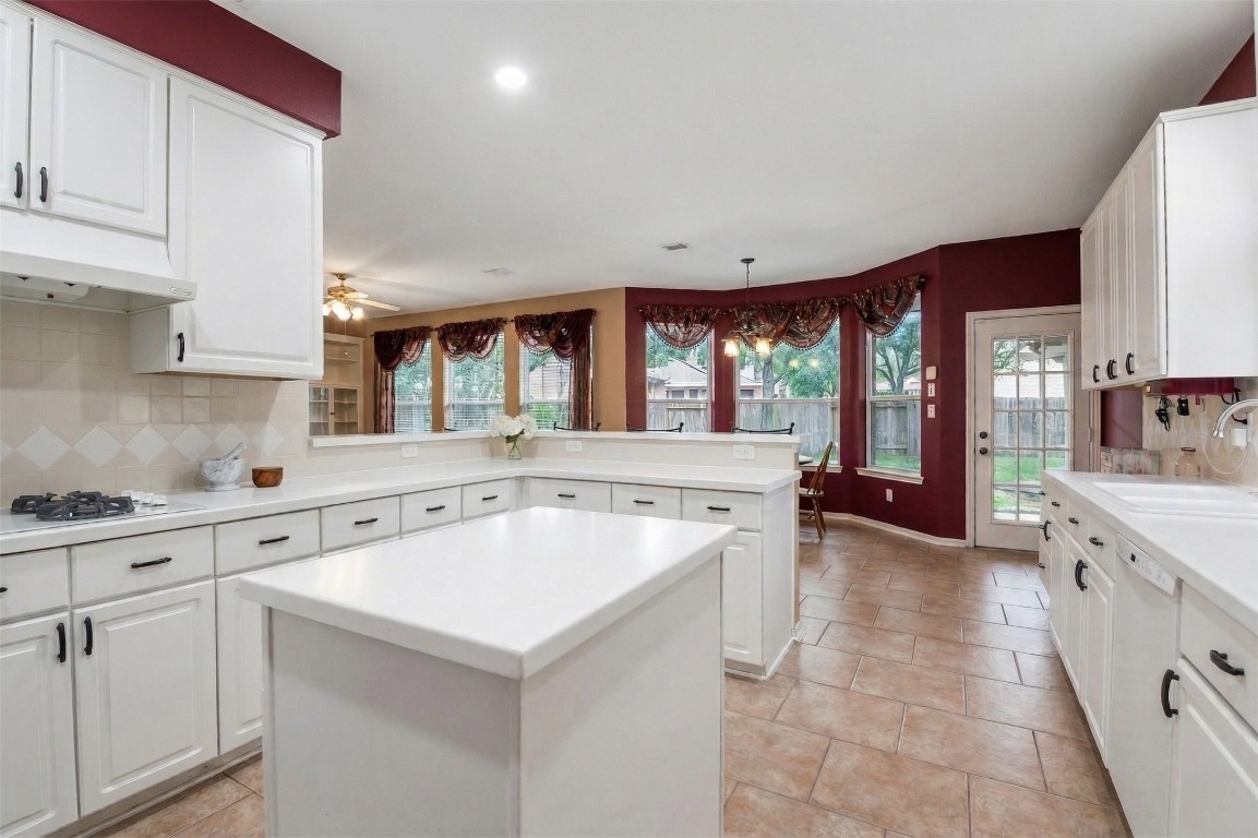 20423 Forest Drive Spring, TX 77388 - Photo 22 of 49 a kitchen with a stove a sink and a refrigerator