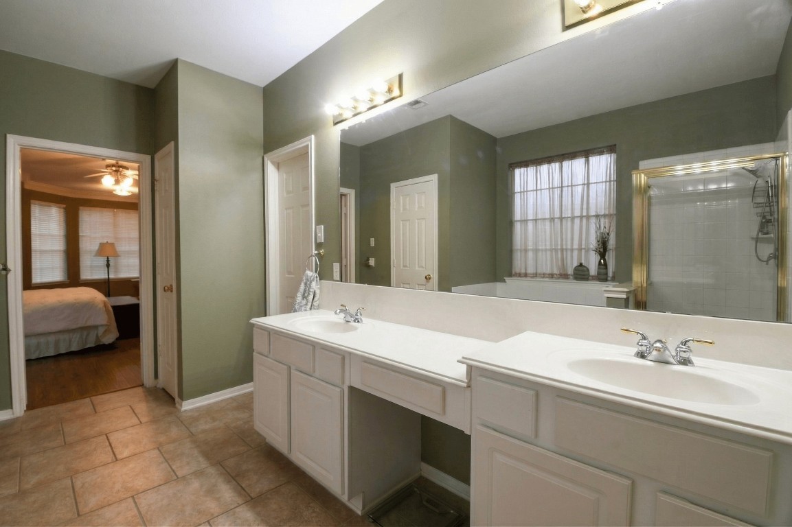 20423 Forest Drive Spring, TX 77388 - Photo 29 of 49 a en suite bathroom with a double vanity sink and a mirror