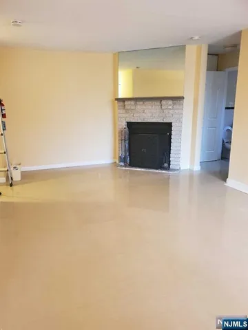 a view of empty room with a fireplace