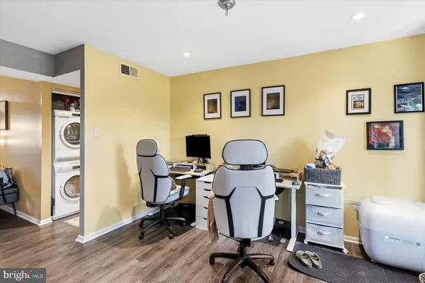 a view of a workspace with furniture and a window