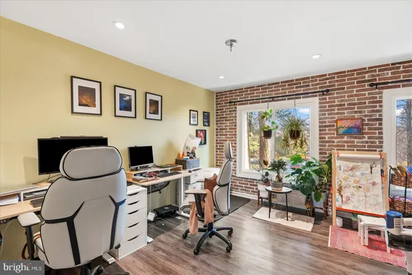 a work room with furniture and a potted plant