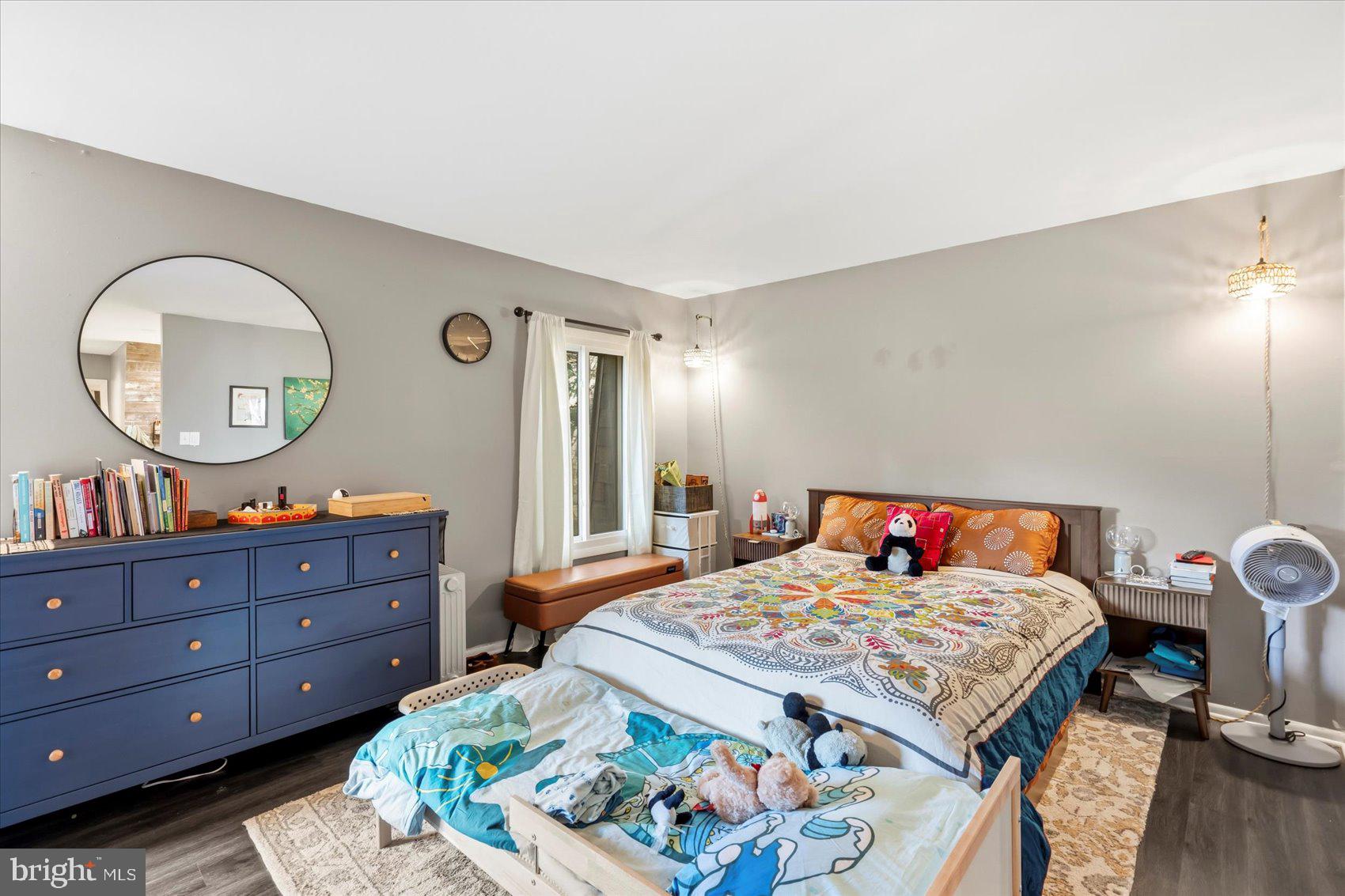 5239 West Running Brook Road, Unit 302 Columbia, MD 21044 - Photo 17 of 33 a bed room with a bed and a mirror