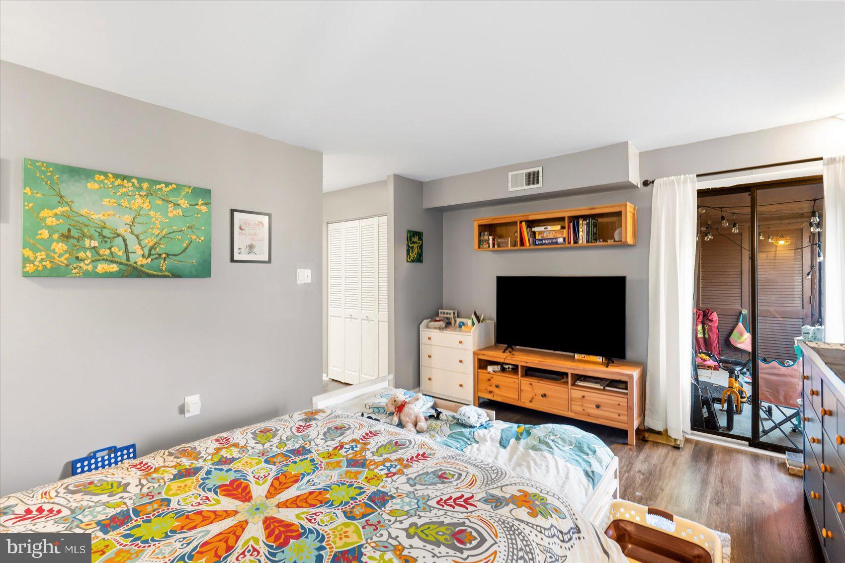 5239 West Running Brook Road, Unit 302 Columbia, MD 21044 - Photo 19 of 33 a bedroom with bed and a flat screen tv