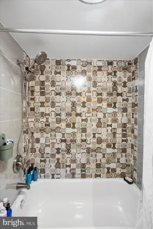 a bathroom with a bathtub and shower