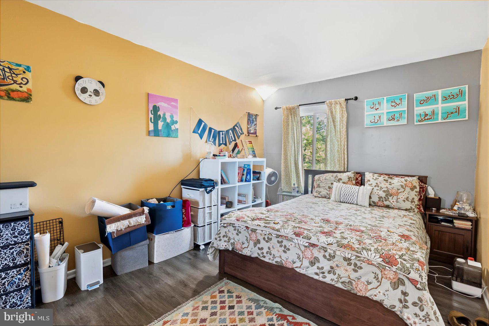 5239 West Running Brook Road, Unit 302 Columbia, MD 21044 - Photo 22 of 33 a bedroom with a bed and wooden floor