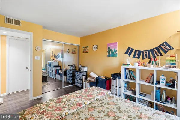 a living room with a book shelf and a book shelf