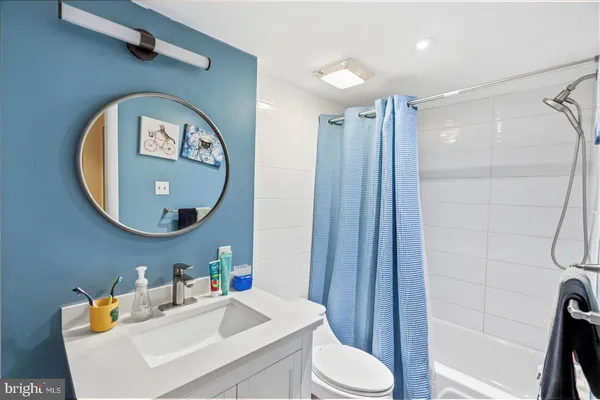 a bathroom with a sink a toilet and a mirror