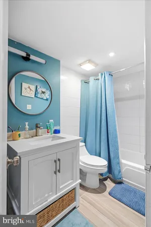 a view of bathroom with a toilet a sink and a mirror
