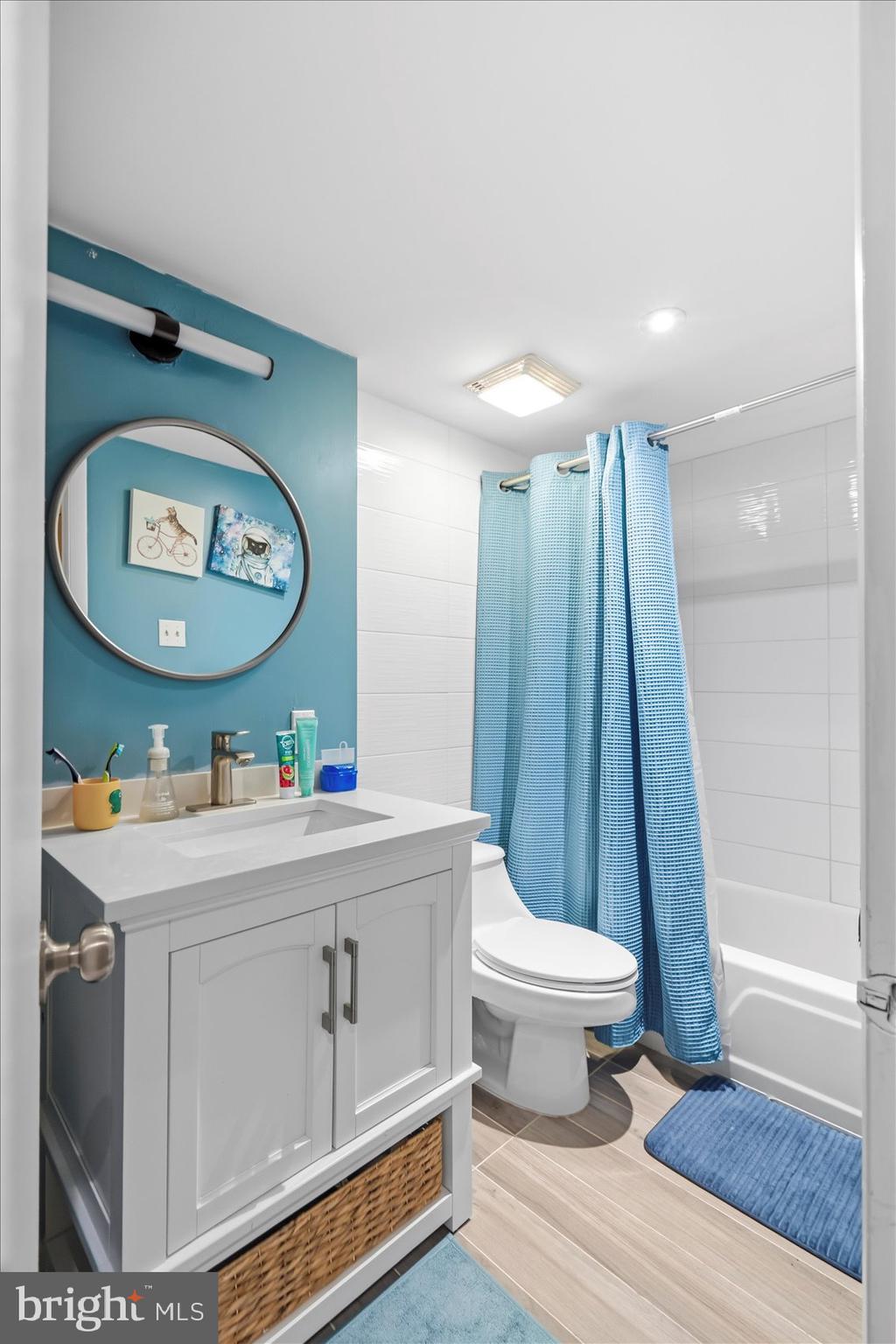 5239 West Running Brook Road, Unit 302 Columbia, MD 21044 - Photo 25 of 33 a view of bathroom with a toilet a sink and a mirror