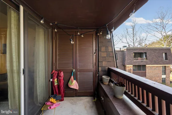 a view of two chairs and table in the balcony
