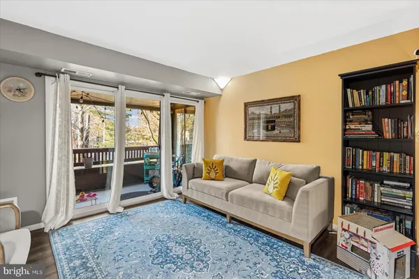 a living room with furniture and a book shelf