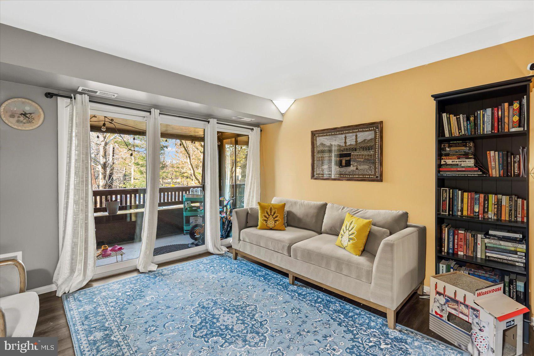 5239 West Running Brook Road, Unit 302 Columbia, MD 21044 - Photo 5 of 33 a living room with furniture and a book shelf