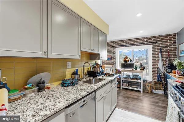 a kitchen with counter top space cabinets and appliances