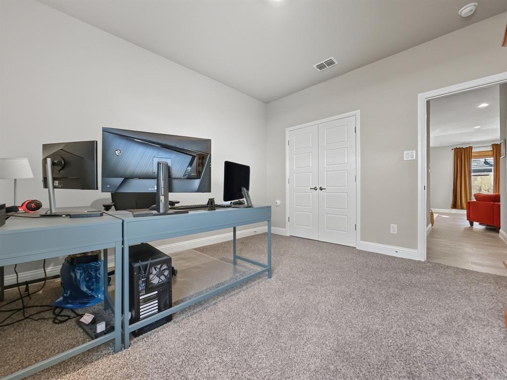 2216 Redwing Drive Denton, TX 76205 - Photo 25 of 38 a room with a bed and a bathroom sink