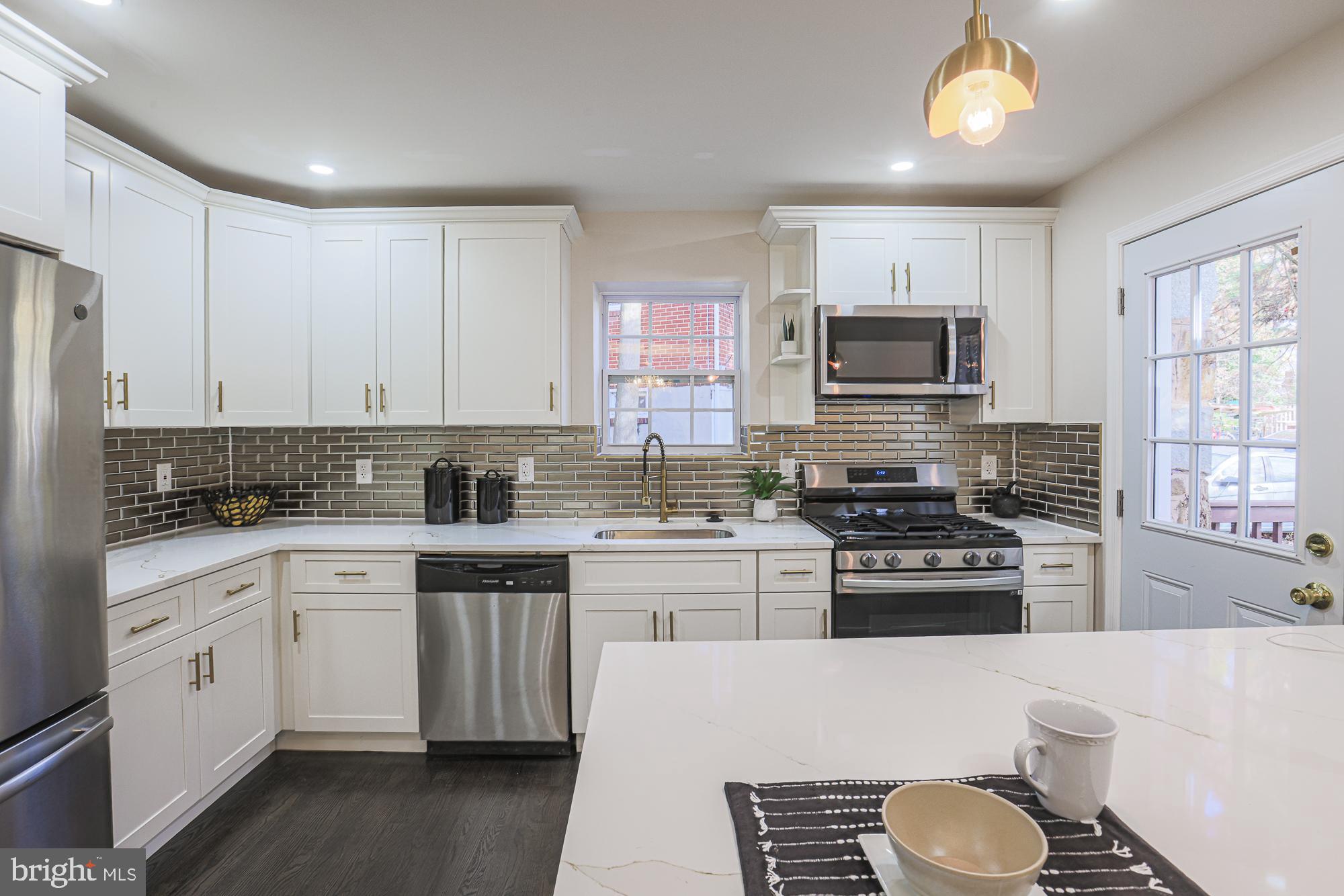3641 Campfield Road Baltimore, MD 21207 - Photo 6 of 61 a kitchen with a sink stove top oven and refrigerator