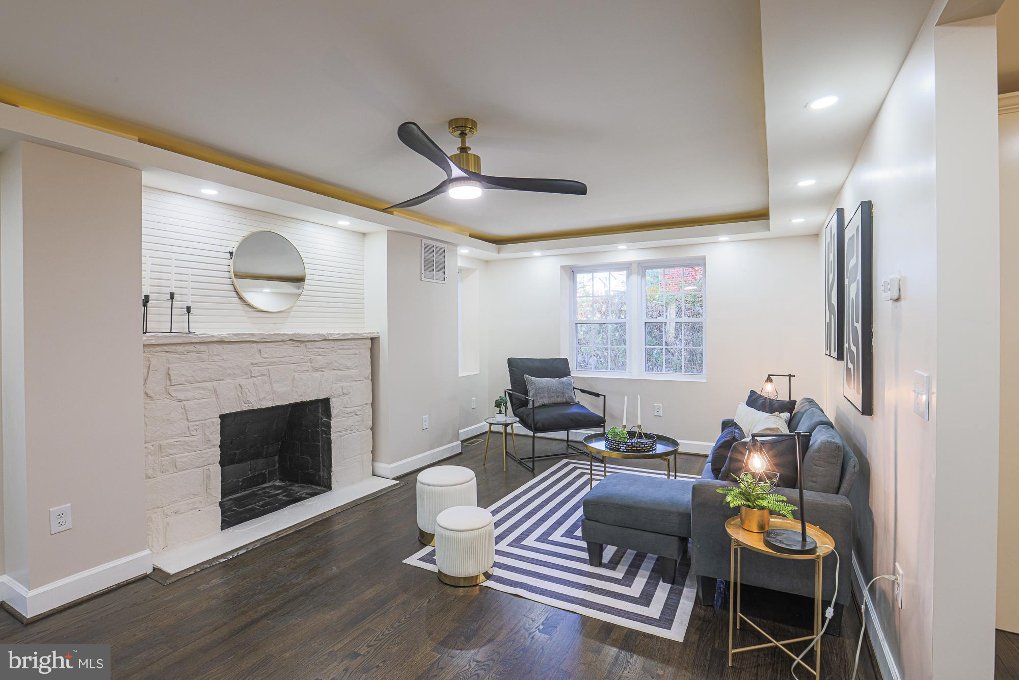 3641 Campfield Road Baltimore, MD 21207 - Photo 10 of 61 a living room with furniture and a fireplace