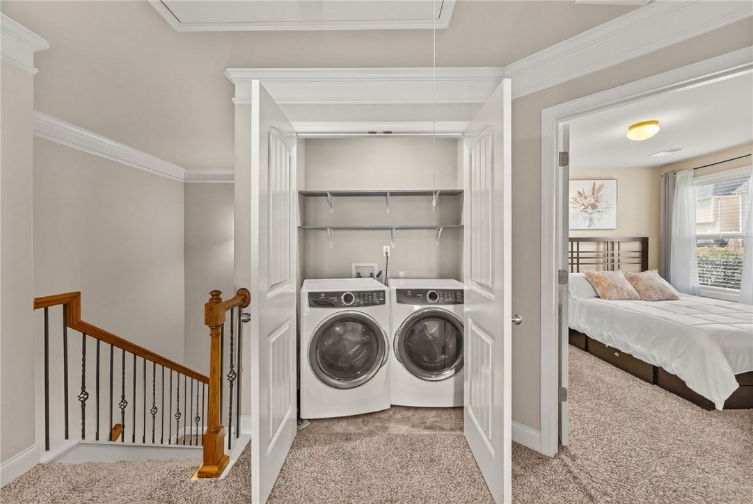 874 Wild Orchard Lane Woodruff, SC 29388 - Photo 20 of 35 This cozy laundry area provides practical convenience adjacent to a comfortable bedroom space.