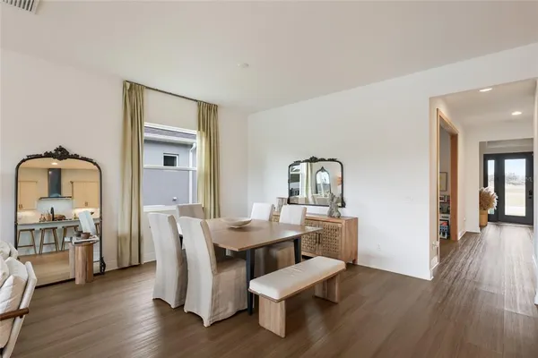 a dining room with furniture and wooden floor