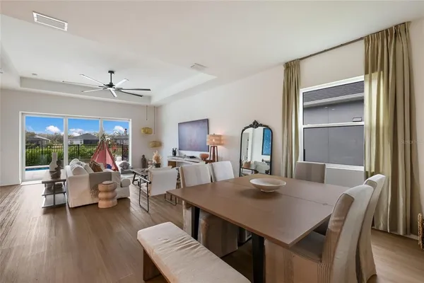 a view of a dining room with furniture window and wooden floor