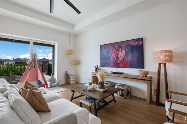 a living room with furniture and a wooden floor