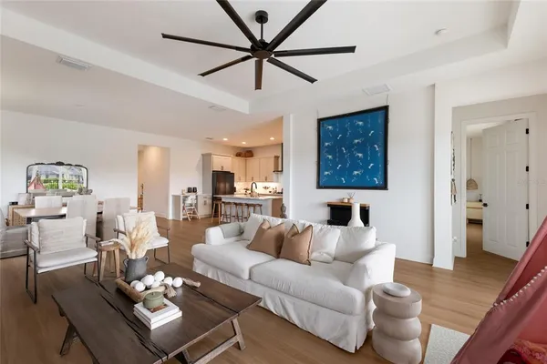 a living room with furniture a window and wooden floor