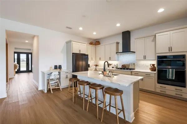 a large kitchen with kitchen island a dining table and chairs