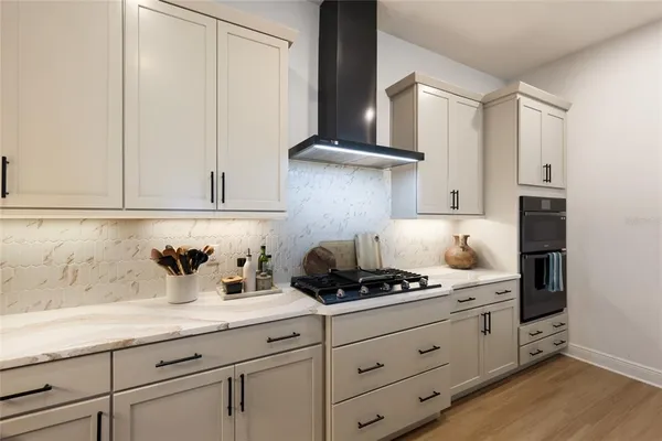 a kitchen with white cabinets and appliances