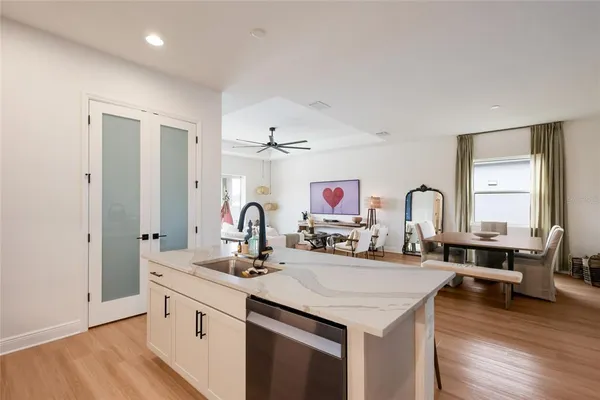 a kitchen with kitchen island a sink stove and wooden floor