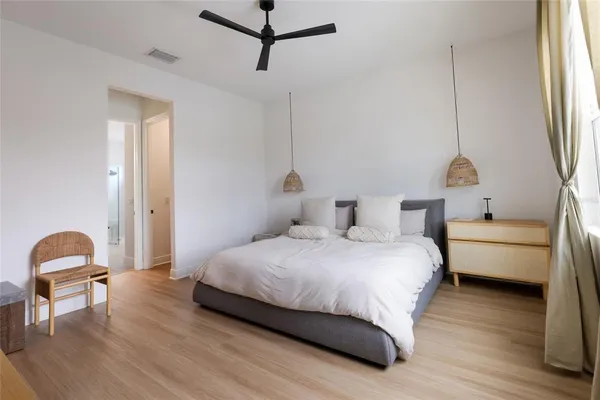 a bedroom with a bed and a window