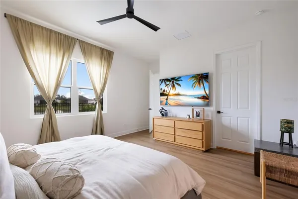a bedroom with a bed and a large window