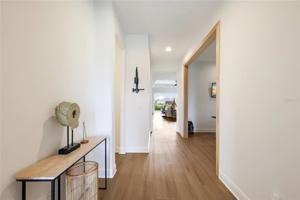 a view of hallway with wooden floor