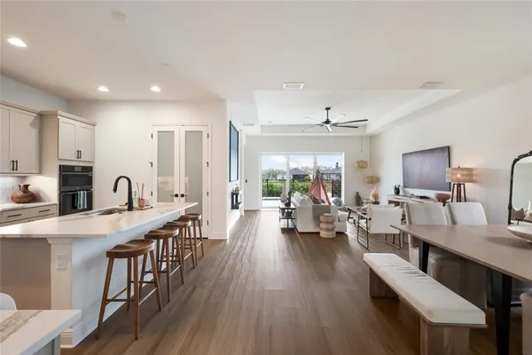 a living room with furniture wooden floor and a table