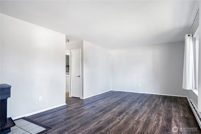 a view of a room with wooden floor and window