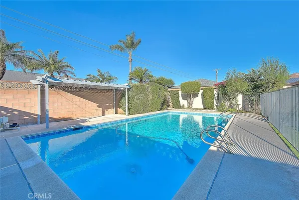 a view of swimming pool with a lounge chairs